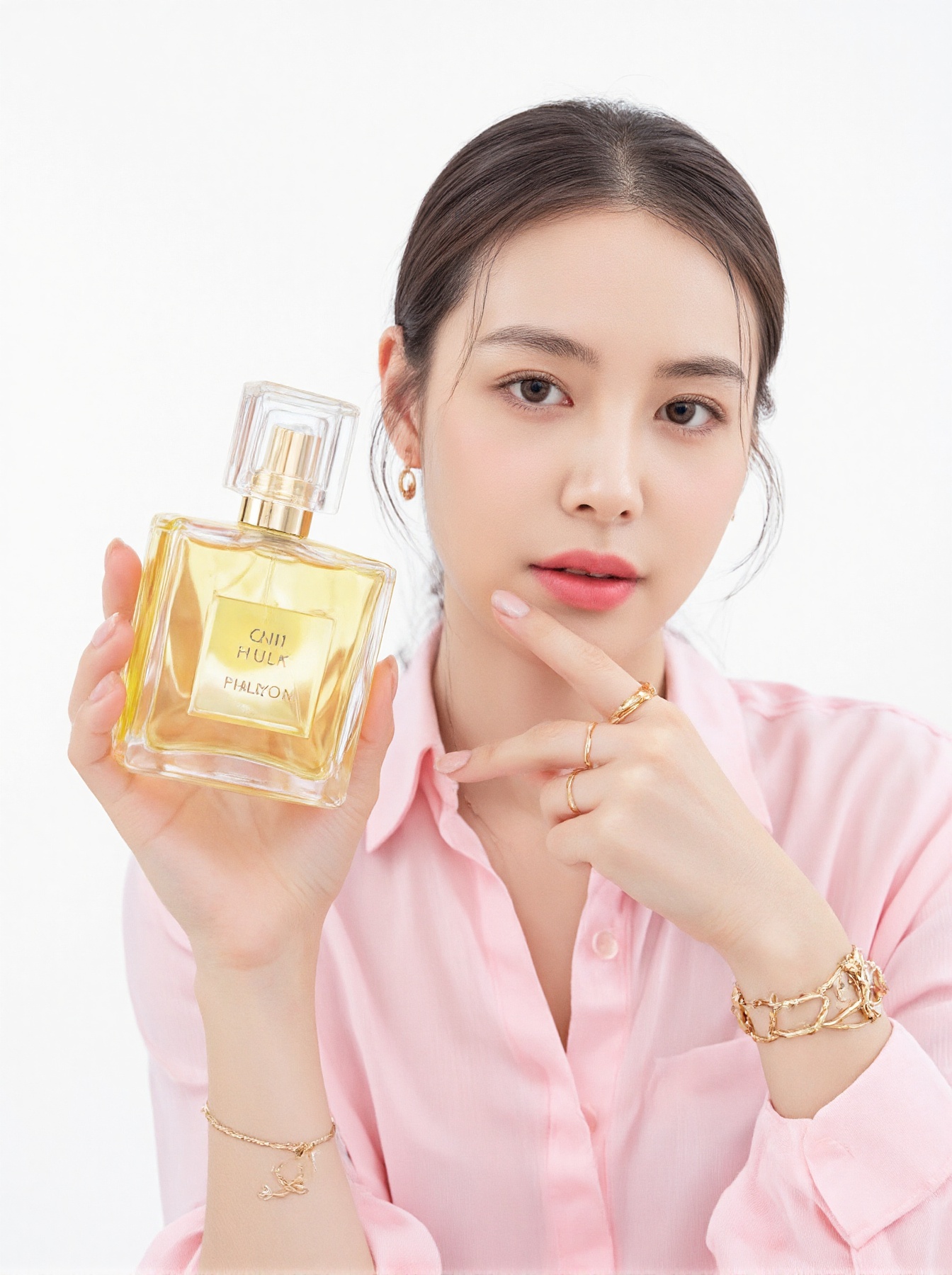 a woman in a pink shirt is holding a yellow bottle of perfume in her left hand. Her right hand is adorned with a gold brac...