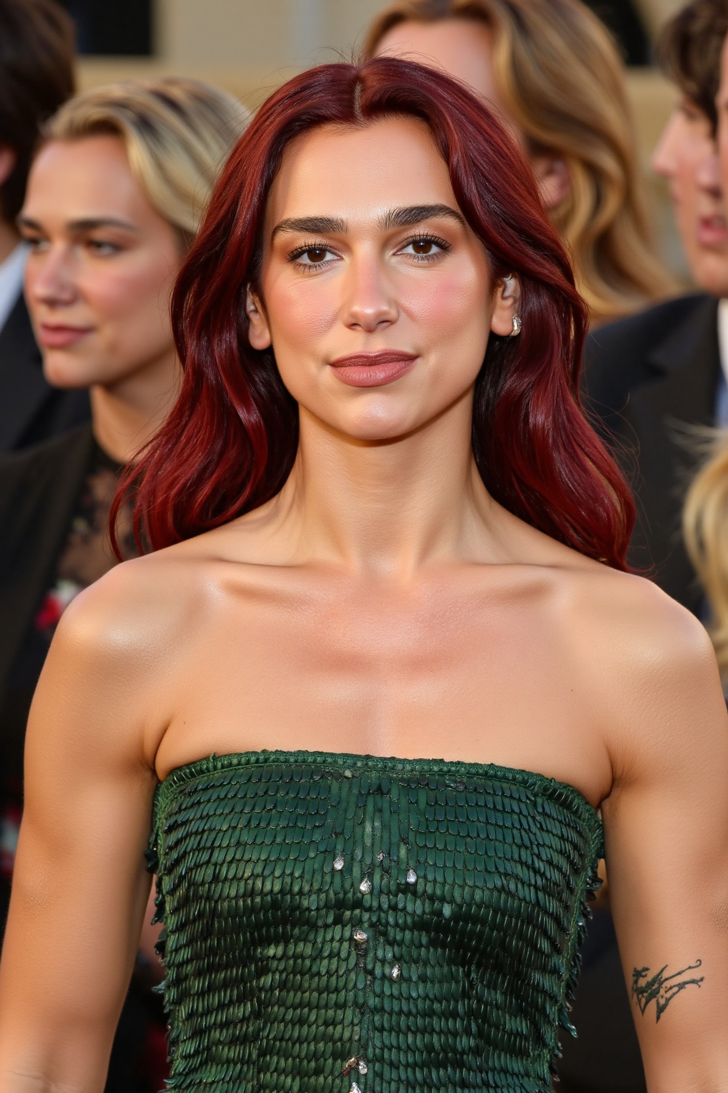 A stunning woman named DuaL1pa with flowing red hair,  wearing a luxurious green strapless gown. Captured in a candid clos...