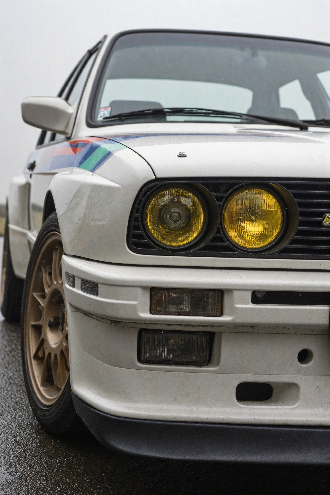 Sony alpha 9 with macro prime lenses hyper realistic side Close-up of a e30 BMW M3 with yellow headlights with turned bron...