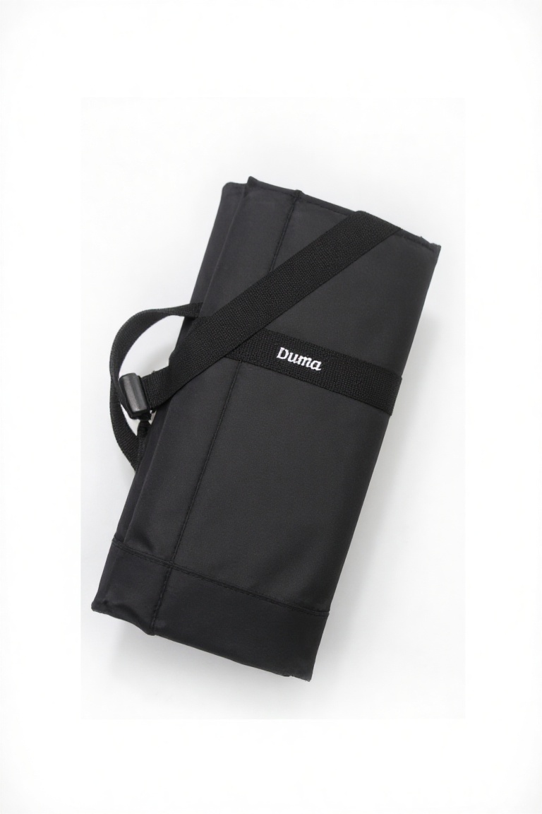 A bold and sleek product shot: a black rectangular duma bag. The bag has the word "Duma" written on it in white text. . Fr...