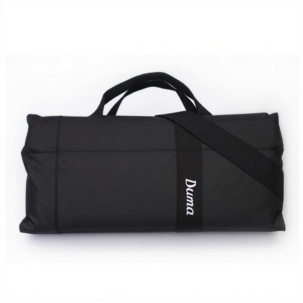 Product view of a black rectangular duma bag. The bag has the word "Duma" written on it in white text. Studio product,  in...