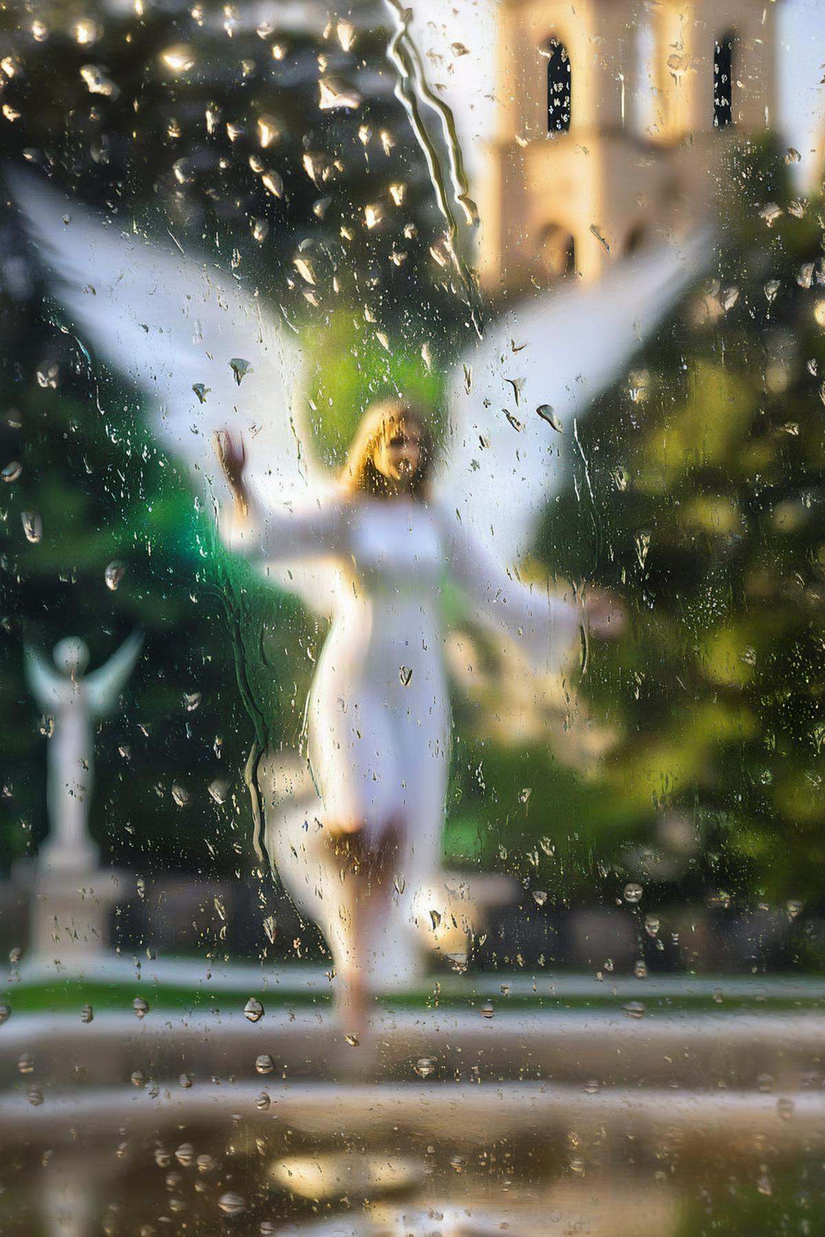 looking outside of cathedral window,  blurry view of green park and levitating angel behind window pane,  watrops on Tenso...