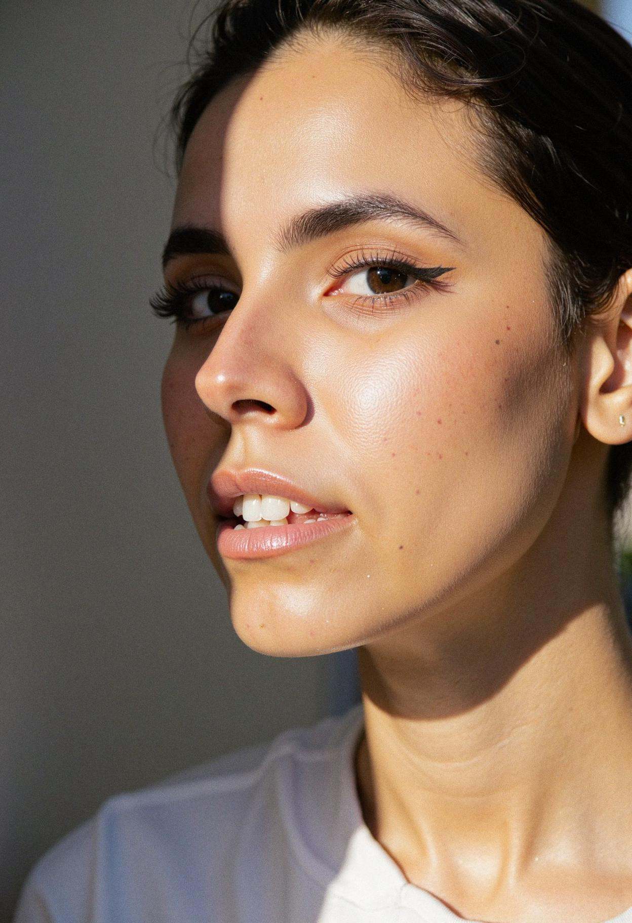 A close-up shot of a woman in profile,  her face evenly lit by diffused natural light,  emphasizing her elegant features a...