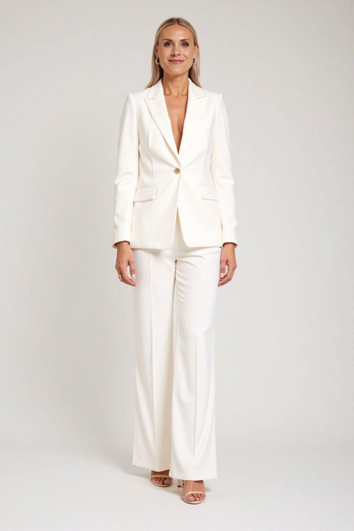 photo of exp woman,  The image features a person wearing a stylish white suit consisting of a blazer and wide-legged pants...