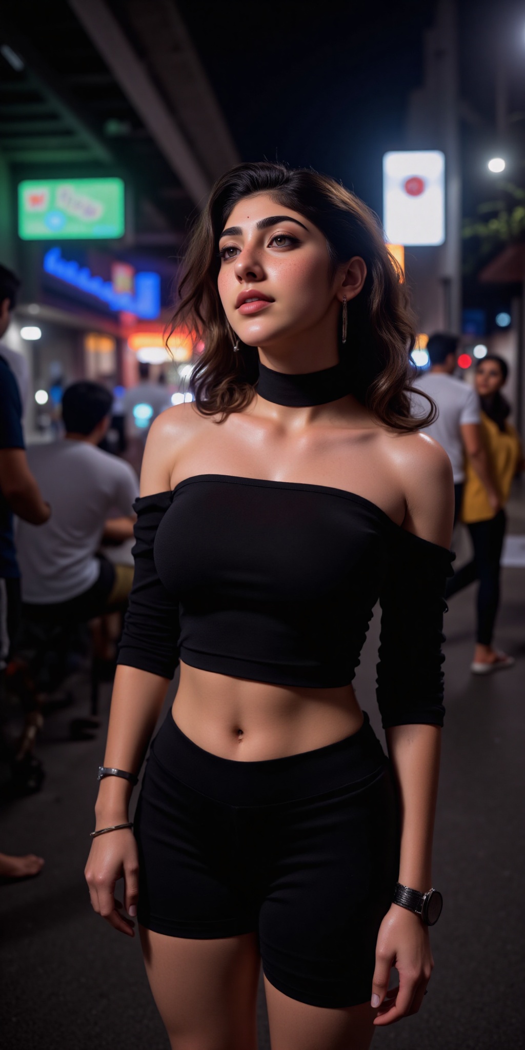 Indian woman A young woman with light brown skin and dark wavy hair stands in a narrow dimly lit Asian street at night. Sh...