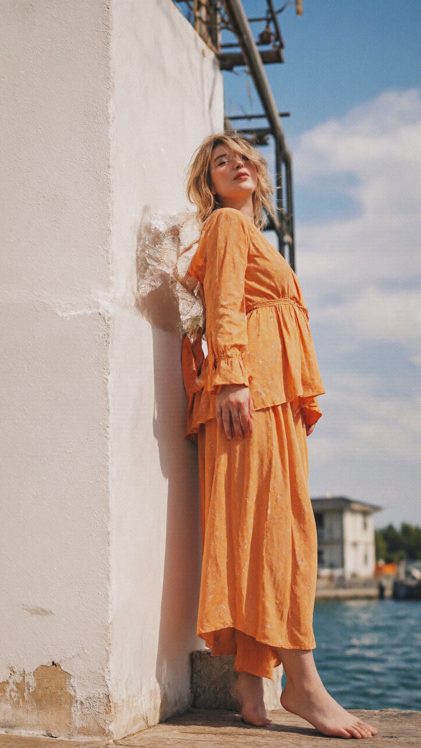 a woman in an orange dress standing on a white wall,  idian dress,  catalog on Tensor.Art