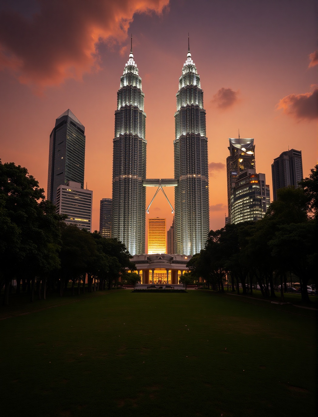 a kuala lumpur malaysian cityscape at sunset,  showcasing a prominent skyline with a pair of iconic twin towers illuminate...