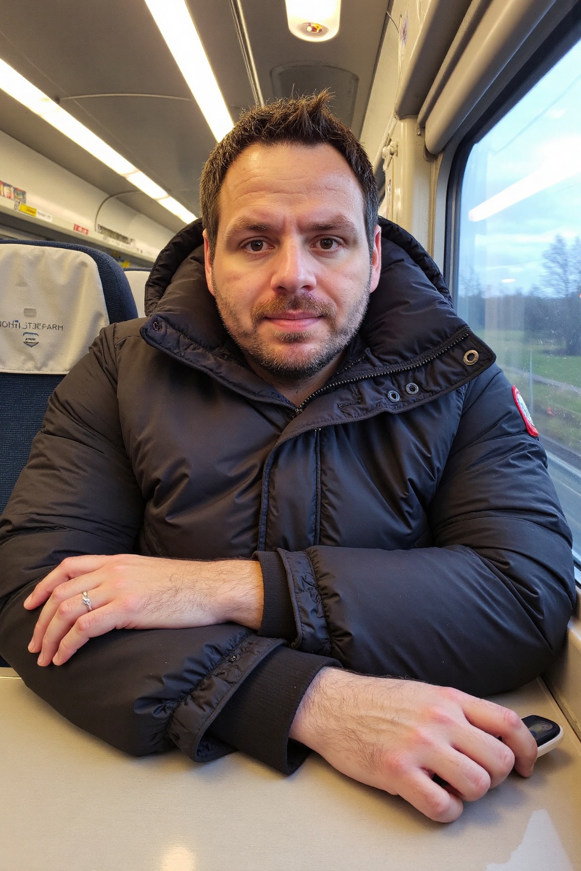 A high-resolution,  professional portrait photograph of a adr1l3w15 man,  sitting inside a train car on Tensor.Art
