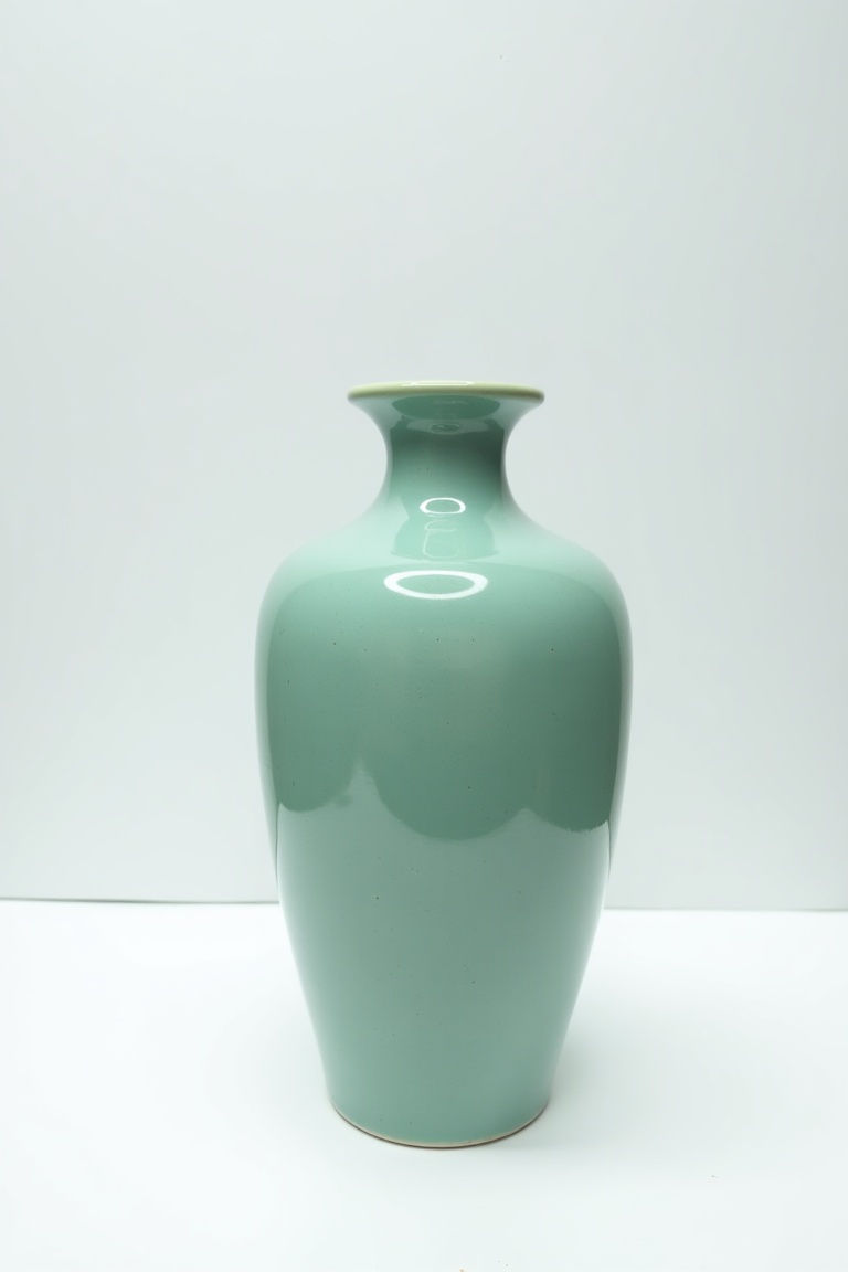 ceramic_vase,  a single celadon green crackle-glazed ceramic vase,  traditional symmetrical shape on Tensor.Art