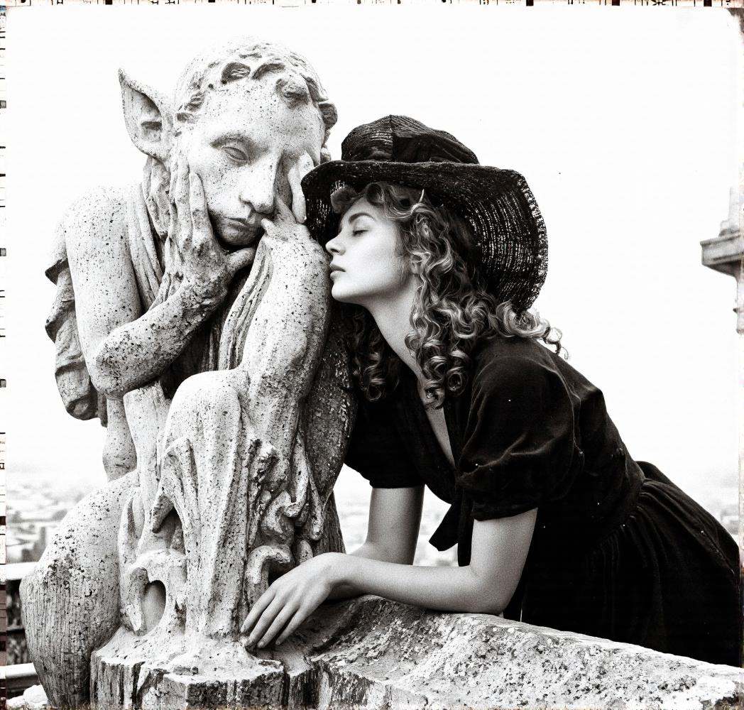 A cinematic photo. A black and white photograph from a close-up camera angle,  featuring a woman with curly hair wearing a...