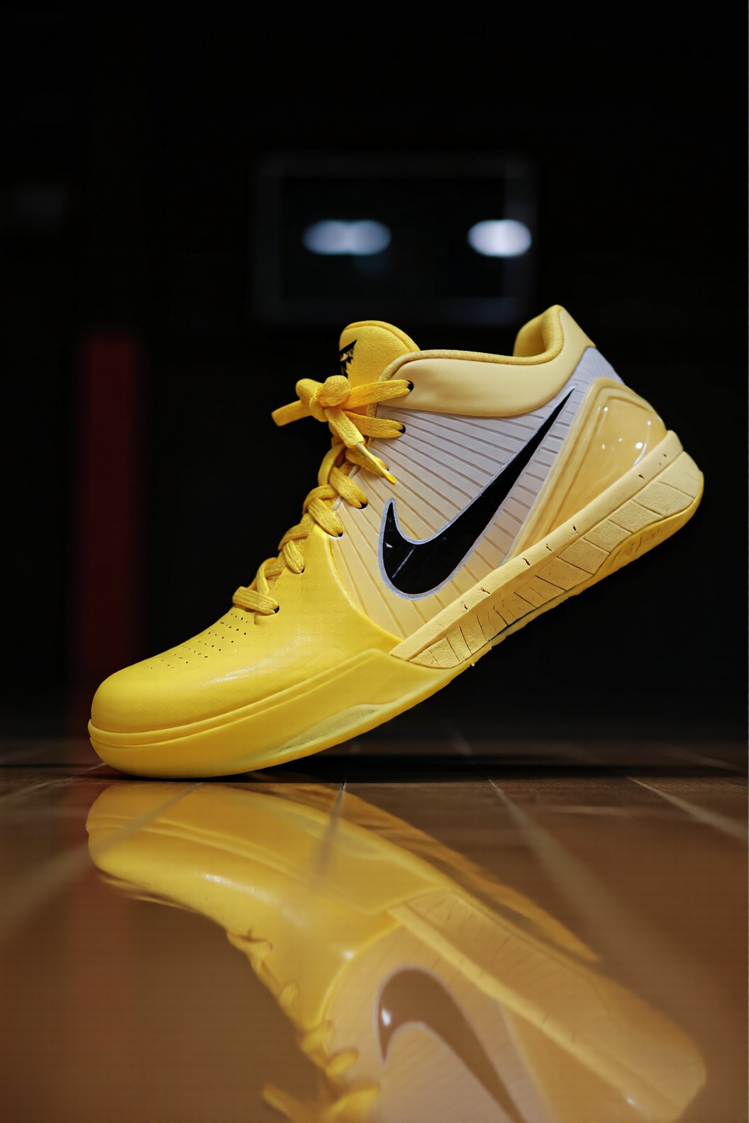Create a vibrant image of the Nike Zoom Kobe 4 in a striking yellow color. Focus on the sleek design and detailed stitchin...