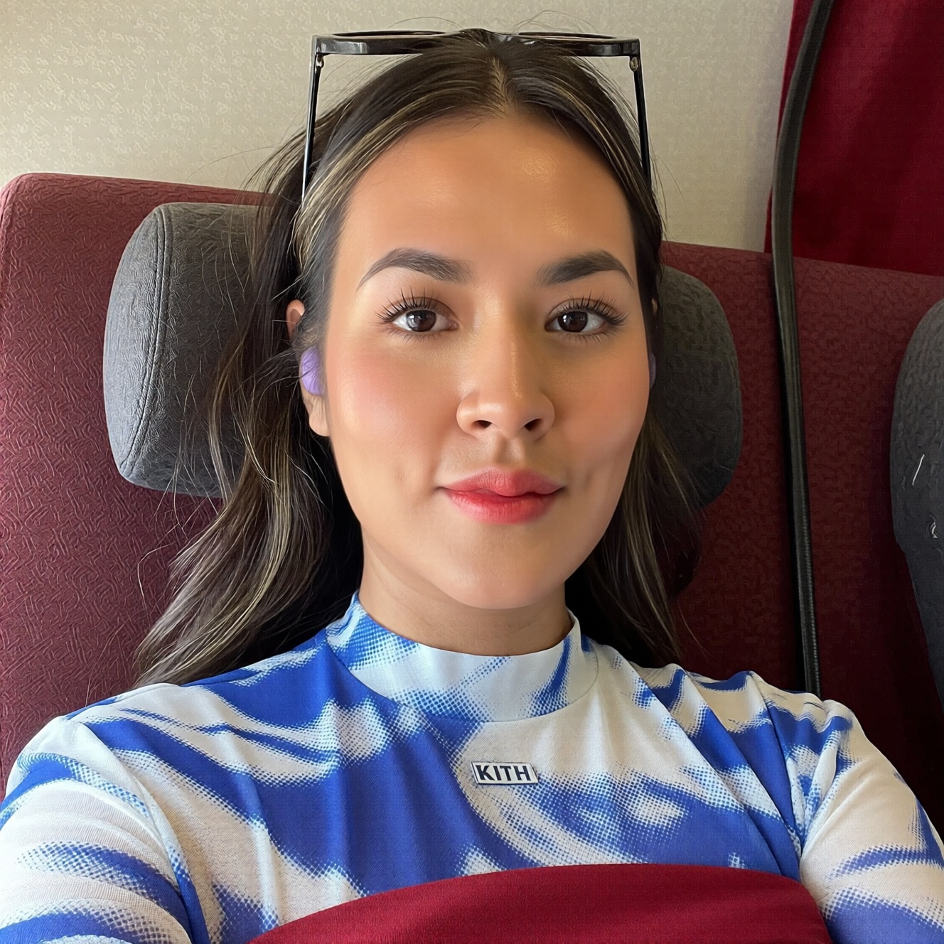 a photo of a r4is4 woman taking a close-up selfie,  displaying a calm and direct expression with soft,  subtle makeup high...