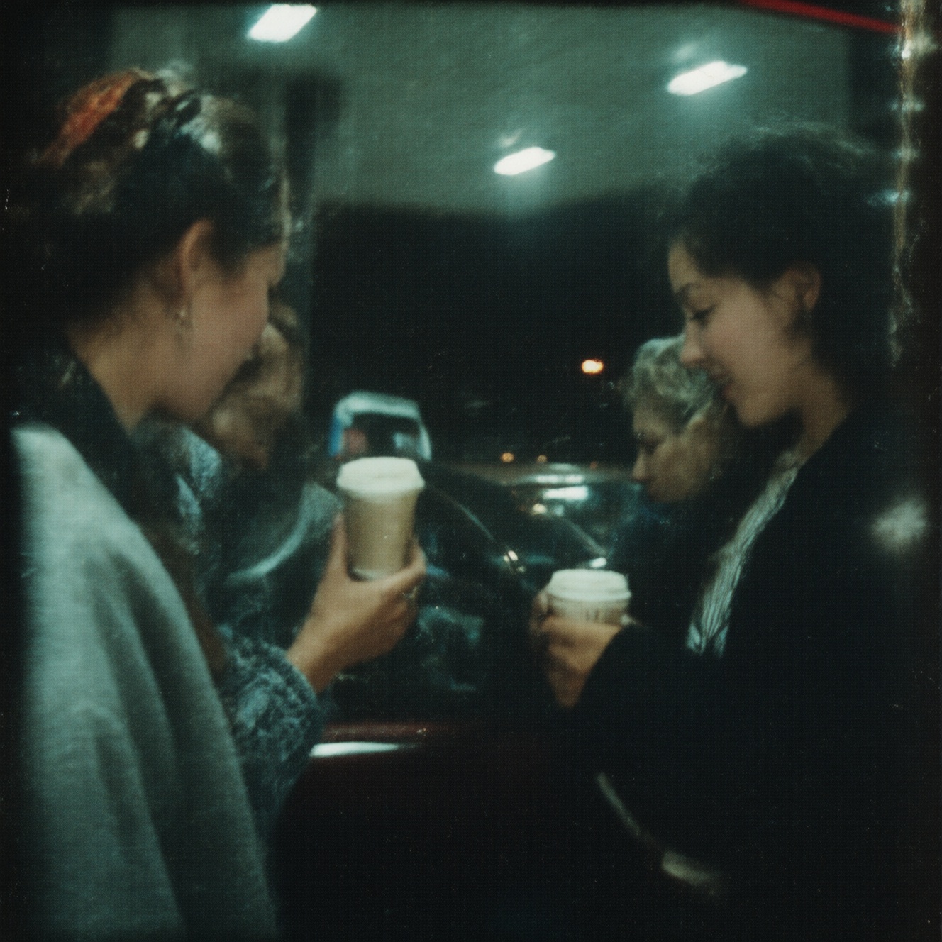 90zVibez ,  A candid 90s photo of friends leaning against a car at a gas station late at night,  holding coffee cups on Te...