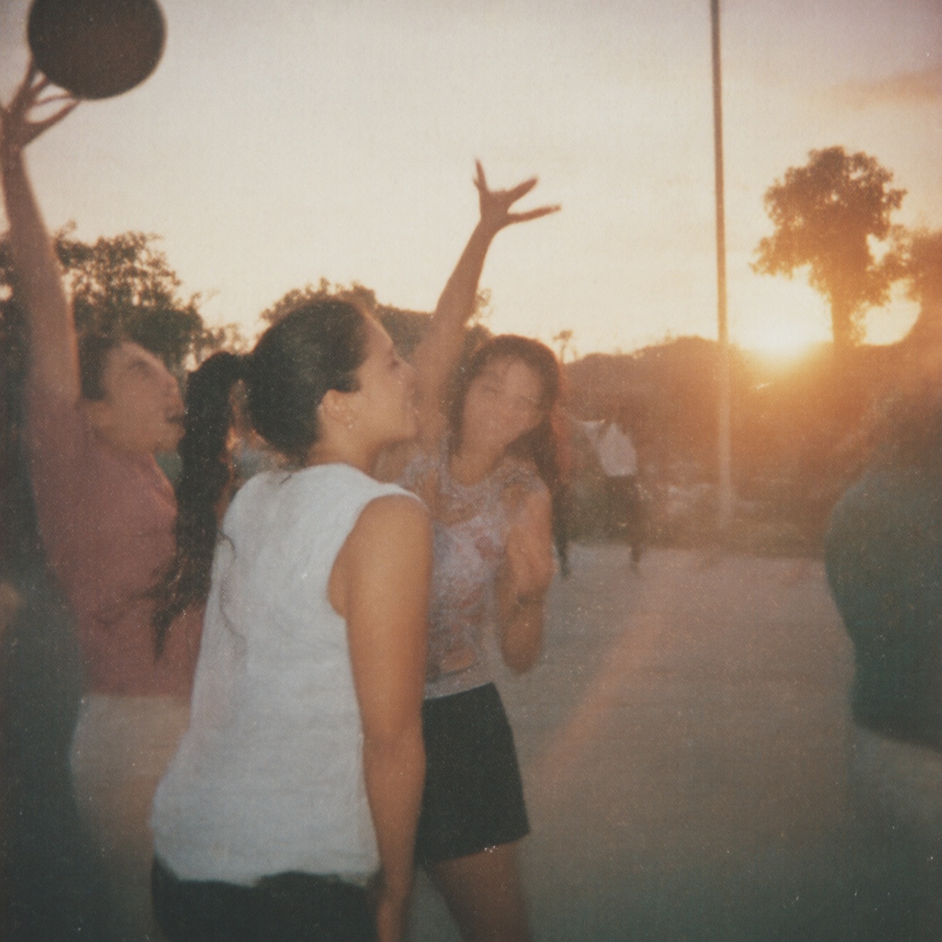 90zVibez ,  A nostalgic 90s photo of friends playing basketball on an outdoor court,  sun setting behind them on Tensor.Art