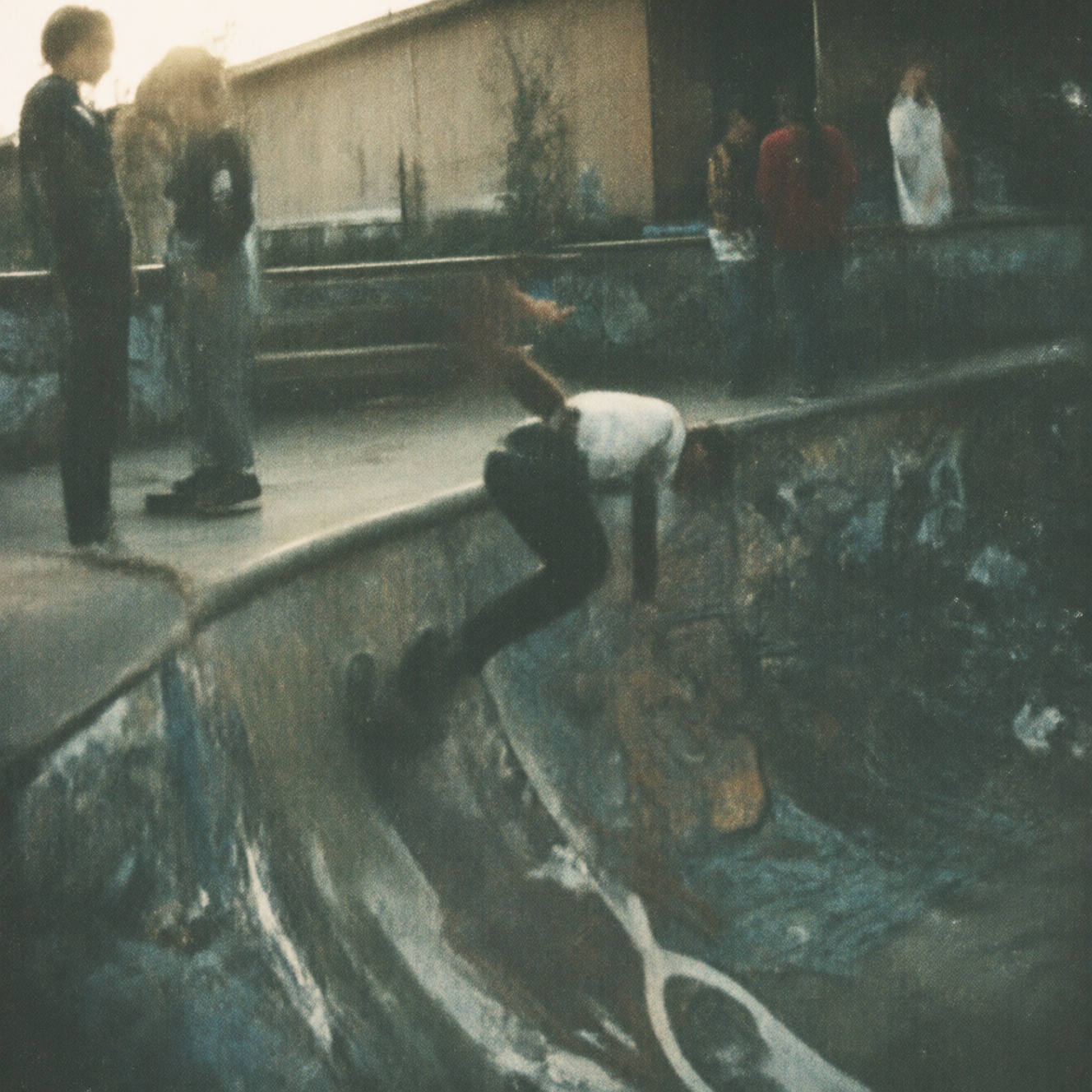 90zVibez,  A 1990s-style candid snapshot of a group of teens at a skatepark,  one doing a trick on a ramp on Tensor.Art